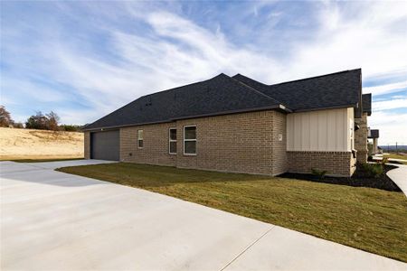 View of property exterior with a garage and a yard