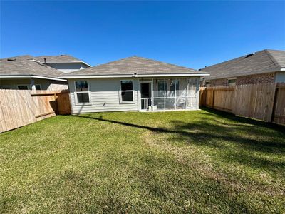 Back of home with 25 year shingles energy reflective roof, also known as a cool roof, reflects sunlight and reduces heat absorption. This can save money on energy bills, improve comfort, and help prevent power outages.