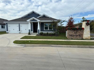 View of front of house featuring a front yard and a garage