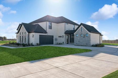 View of front of house with a garage and a front yard