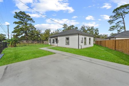 Fully fenced yard with a sliding Iron Gate & additional parking