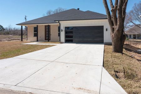 View of front of house with a front lawn and a garage