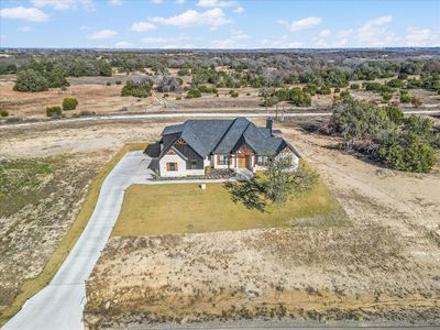 Aerial photo looking North over home. Front has slight slope but backyard is fairly level.