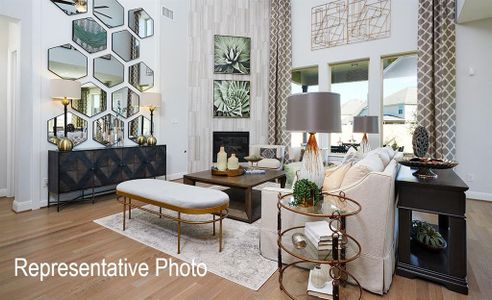 Living room featuring a high ceiling, wood-type flooring, and a tile fireplace