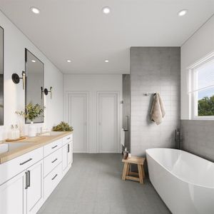 Bathroom featuring vanity, a tub, and tile walls