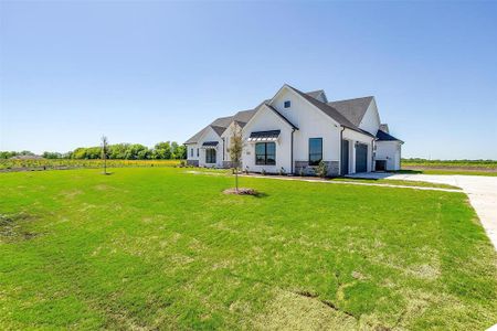 Modern farmhouse style home featuring a front yard