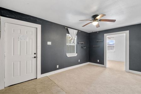 Spare room with ceiling fan and light colored carpet