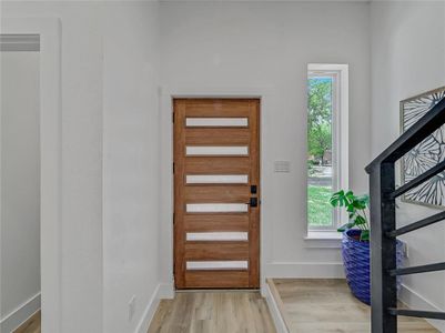 Entrance foyer featuring light hardwood / wood-style floors