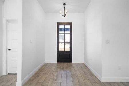 Foyer entrance featuring a chandelier and light wood-type flooring