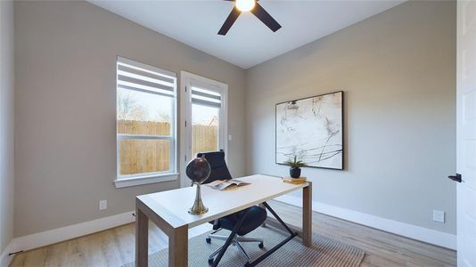 This flexible space can serve as a cozy bedroom or a productive home office. Large windows allow natural light to fill the room, making it a bright and inviting area.