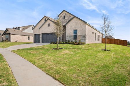 View of front of property featuring a front yard and a garage