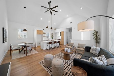 Living/kitchen/dining areas enveloped together creating a spacious and organized feel.