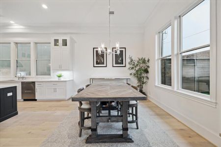 Casual dining area with chandelier and back yard views.