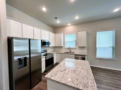 Huge island kitchen, window over the sink & granite counters!