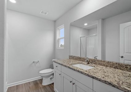 Master bath with a granite vanity.