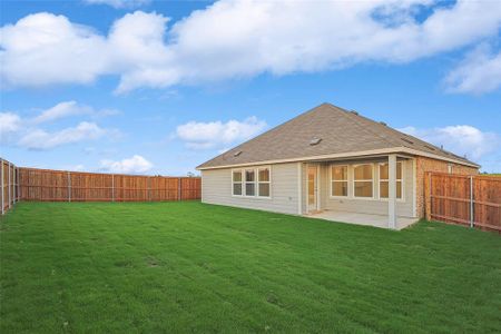 Rear view of house with a patio area and a yard