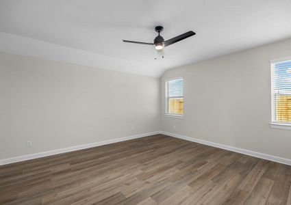 Master bedroom with plank flooring and a ceiling fan