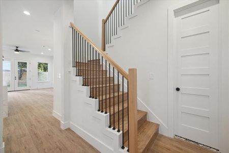 The entryway has the staircase to the second floor. Luxury LVP white oak floors are found throughout the entire house.