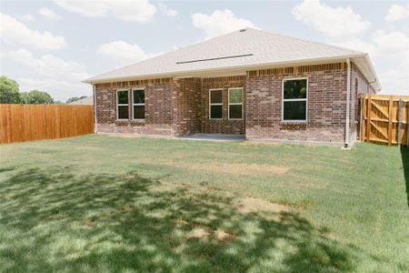 Back of house with a yard and a patio area