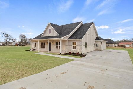 View of front of property with a front lawn and covered porch