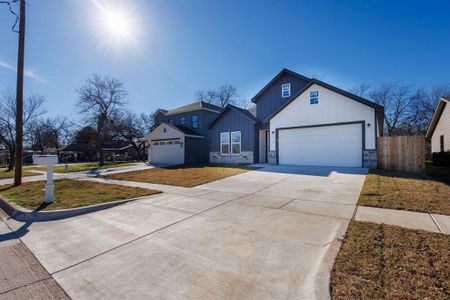 Modern farmhouse with a front yard and a garage