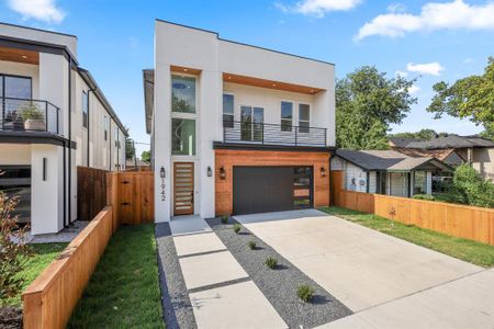 Contemporary house featuring a balcony and a garage