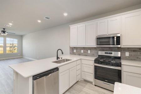 Kitchen featuring stainless steel appliances, sink, and kitchen peninsula