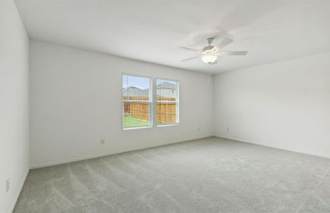 Spacious owner's suite with large windows *real home pictured