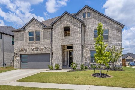 View of front facade with a garage and a front yard