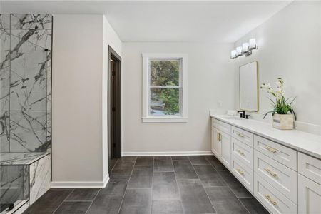 Bathroom featuring vanity, tile floors, and tiled shower