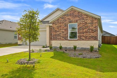 View of front of house with a garage and a front lawn