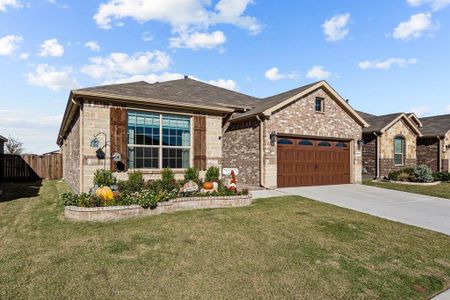 View of front of house with a garage and a front lawn