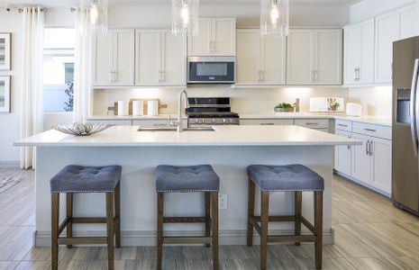 The kitchen island offers additional seating and c