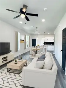 Living room with hardwood / wood-style flooring and ceiling fan