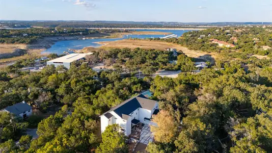 Nestled on nearly half an acre corner lot, this exquisite modern masterpiece sits perched on a gently sloping hill side surrounded by a tree-filled natural landscape with 3,747 sq ft of living space spread over three floors.