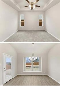 Spare room with ceiling fan with notable chandelier and a raised ceiling