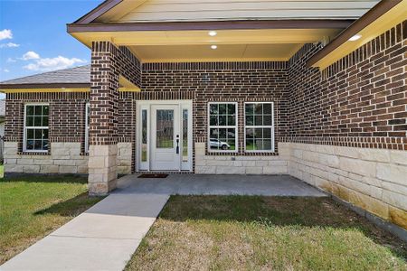 The combination of rich textures and earthy tones creates a sense of permanence and warmth, welcoming you into a residence that exudes curb appeal and craftsmanship.