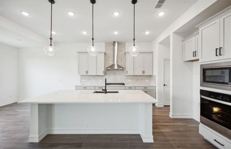 Bright kitchen with oversized island *real home pictured