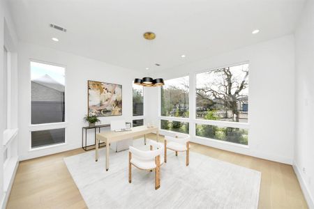 Here's another view of the study/office, highlighting the large windows that bring in abundant natural light and offer pleasant views of the landscaped front yard. This angle showcases how the natural light enhances the space.