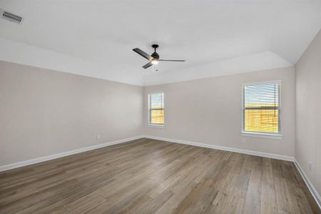 The spacious primary bedroom features luxury vinyl plank flooring and is the perfect place to unwind after a long day.