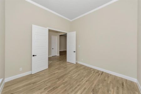 Unfurnished room featuring ornamental molding and light wood-type flooring