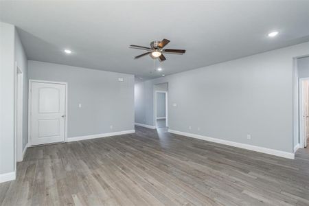 Spare room featuring recessed lighting, ceiling fan, light wood-style flooring, and baseboards