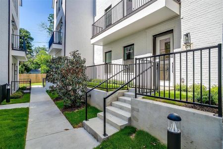 The sleek exterior, with its clean lines and sophisticated finishes, exudes elegance and exclusivity. The secure, wrought-iron gate opens to a meticulously maintained garden space, offering a serene and inviting entrance to this exquisite residence.