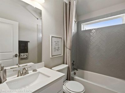 Full bathroom with vanity, shower / tub combo with curtain, and toilet