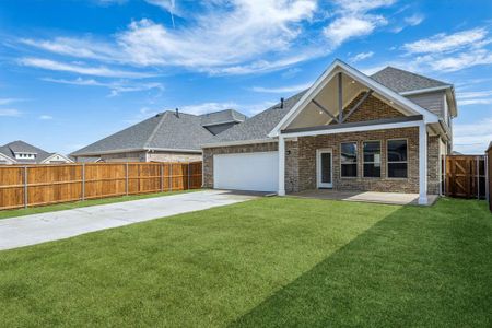 View of front facade with a garage and a front lawn