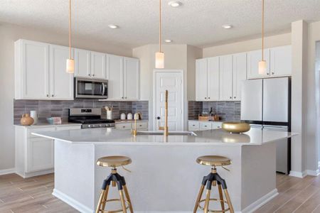 This kitchen is by far any chef’s dream! This spacious kitchen features high ceilings, wood stained cabinets, silestone countertops, SS appliances, modern tile backsplash, recessed lighting, extended counter space for breakfast bar, and a walk-in pantry all overlooking your huge family room.