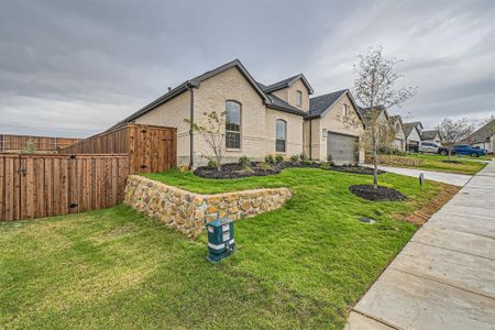 View of front of property with a garage and a front yard