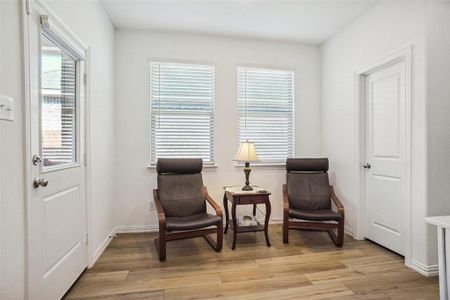 Living area with light hardwood / wood-style flooring