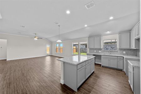 Kitchen with lofted ceiling, dark hardwood / wood-style floors, sink, gray cabinets, and ceiling fan