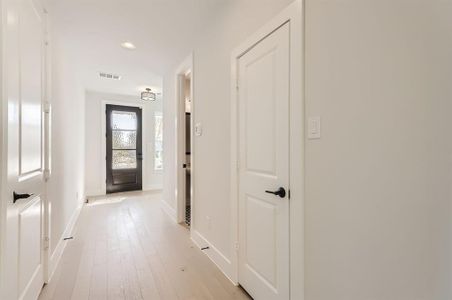 Hallway with light hardwood / wood-style flooring